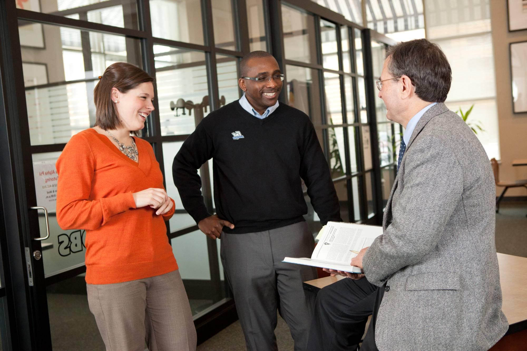 Graduate Program Faculty in a small group meeting